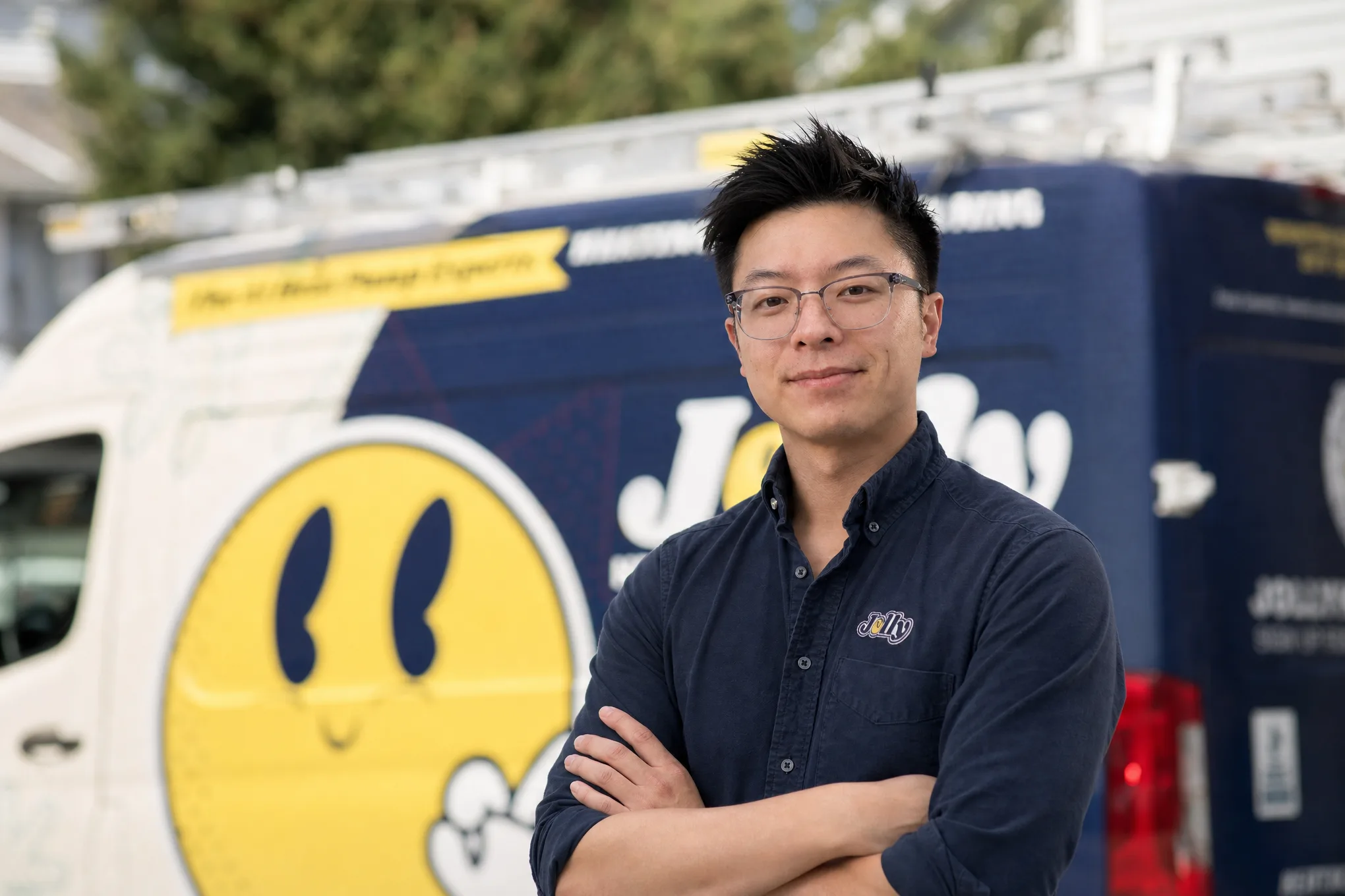 Thomas Lee of Jolly Heating & Cooling standing in front of a Jolly service van